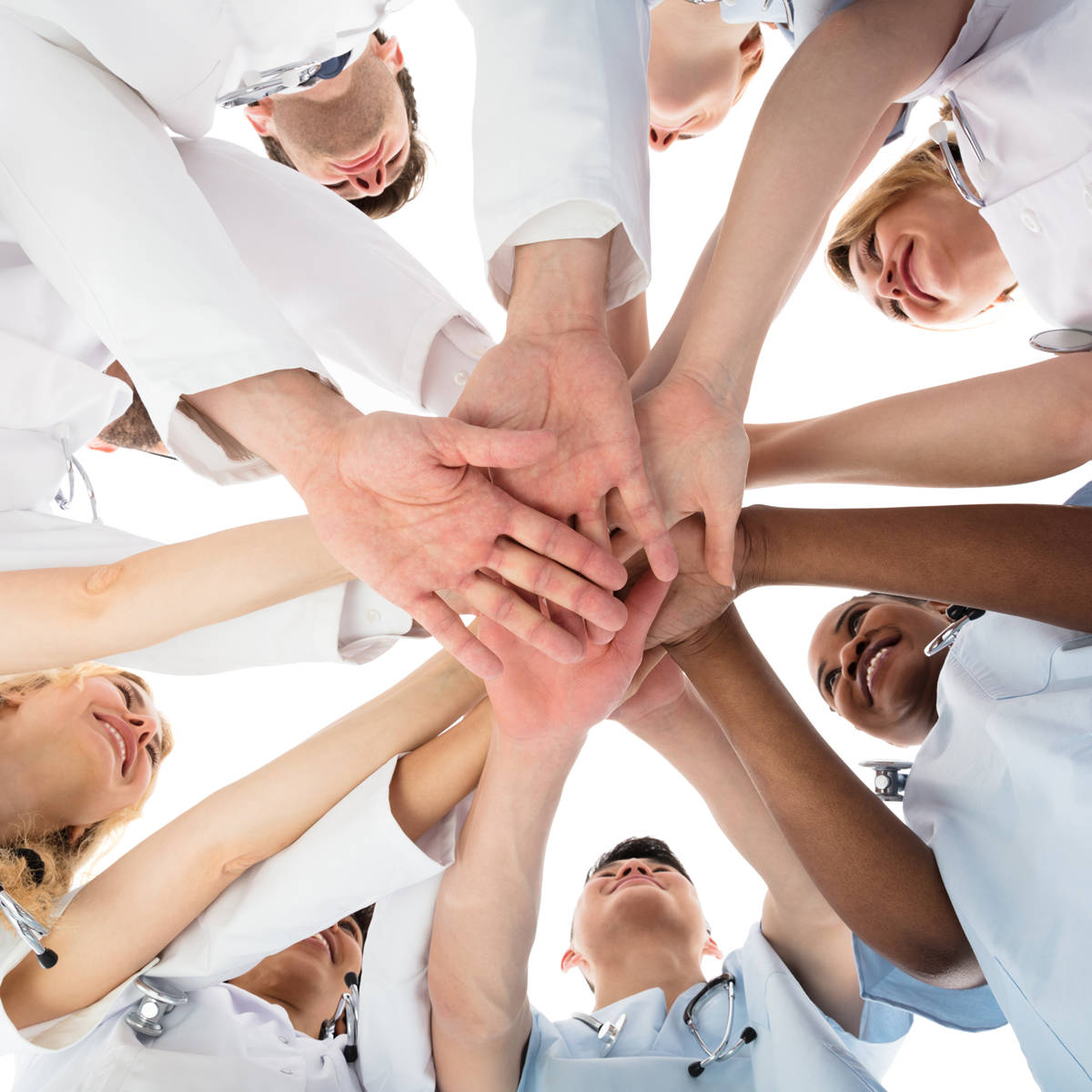 Nurses in circle putting hands together